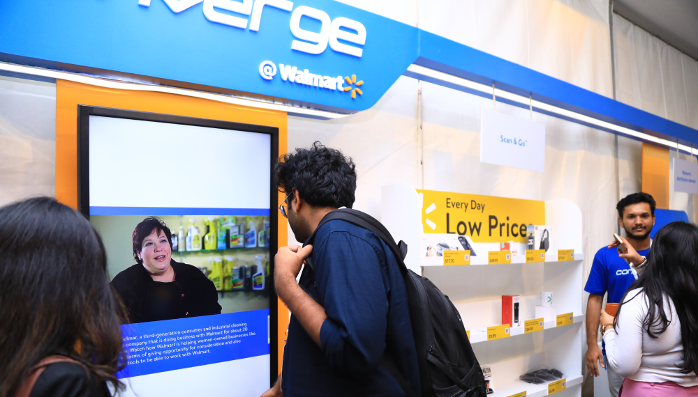 A participant at Converge @ Walmart watches a digital display of Walmart’s innovations at the event’s Experience Zone.