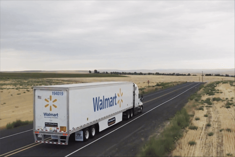 The image is a gif that shows a Walmart truck on the road, heading to a certain destination. There is a headline above the truck that reads 'We are on our way.'