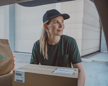 Delivery of oversized items with person using hand truck.