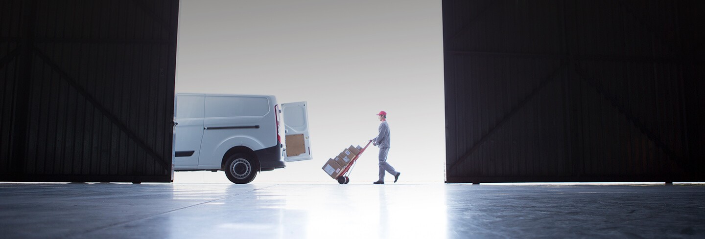 delivery driver moving packages into a van