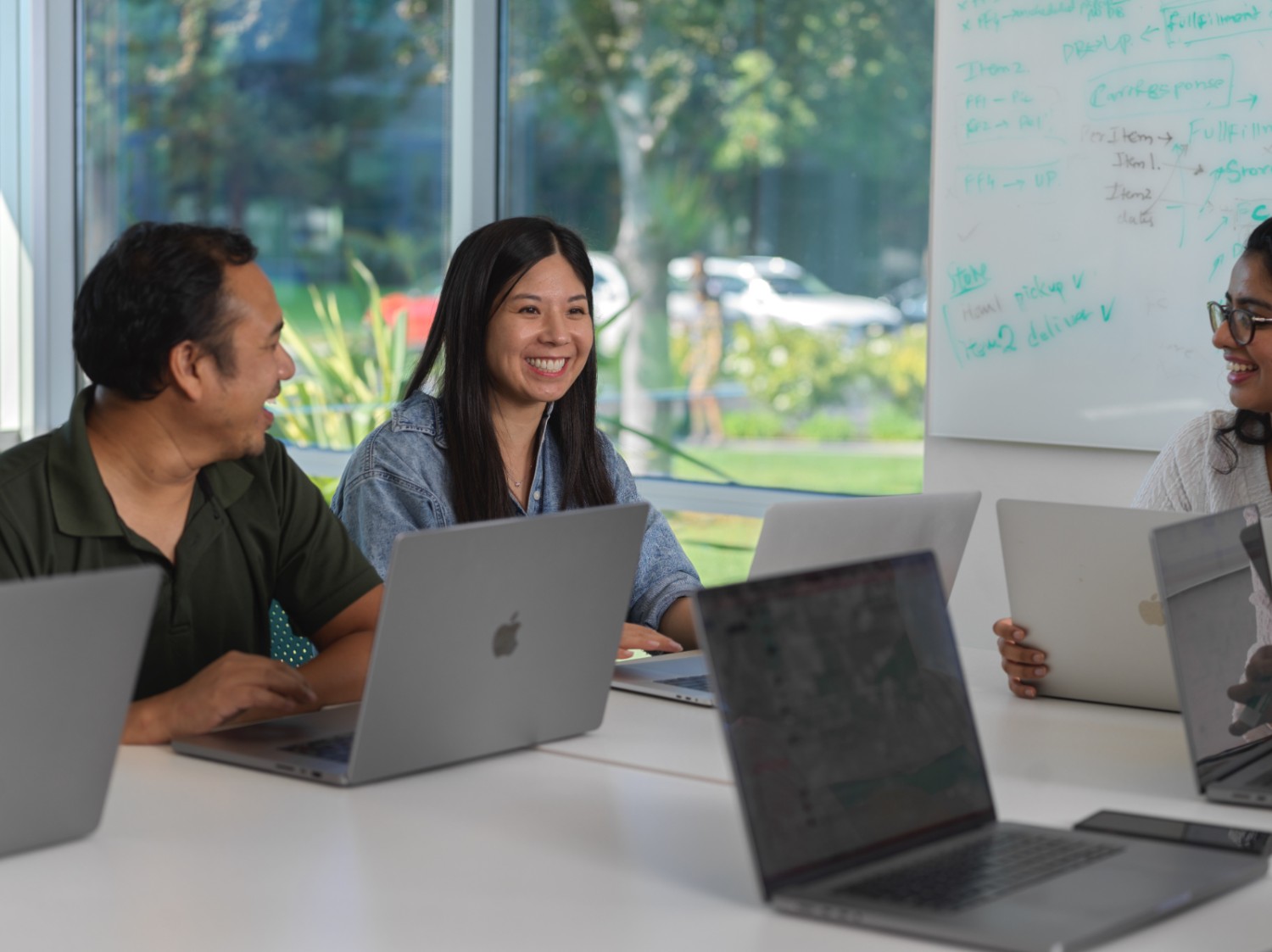 Photo of associates engaging with each other during a meeting.