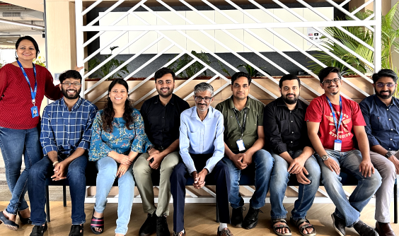 A smiling group of nine Indian IT professionals