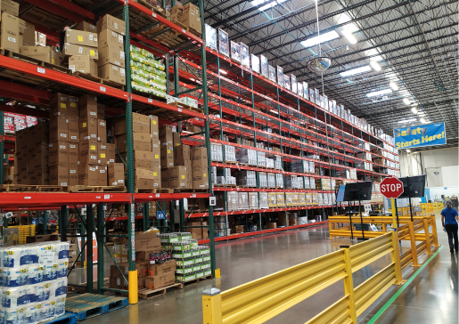 Flow racks filled with labeled brown boxes at a warehouse or Fulfillment Center