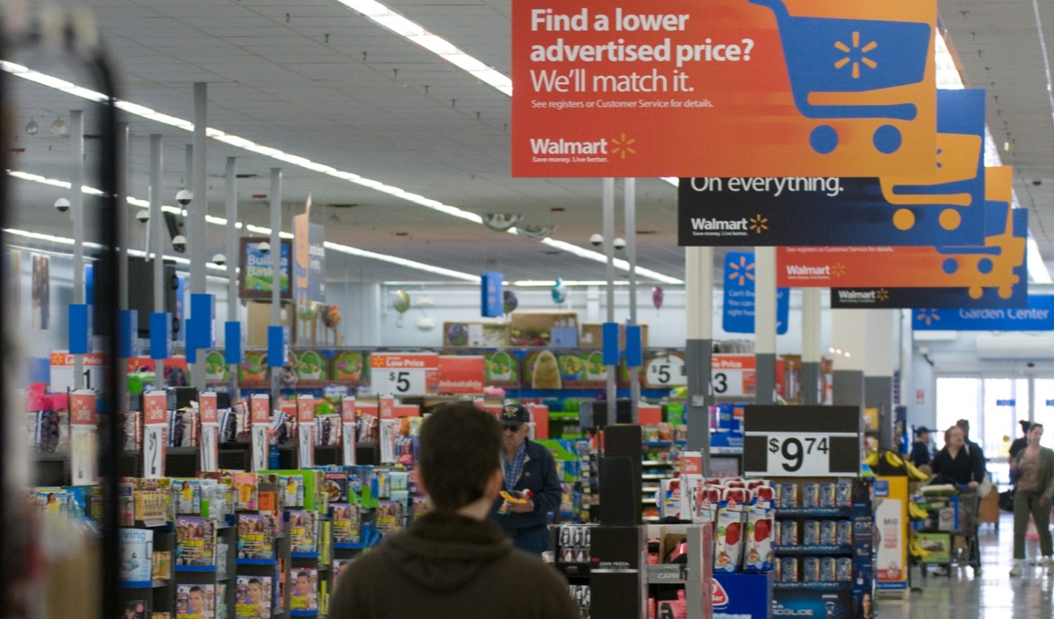 Social Media Orange and blue overhead placard hanging from the roof of a supermarket