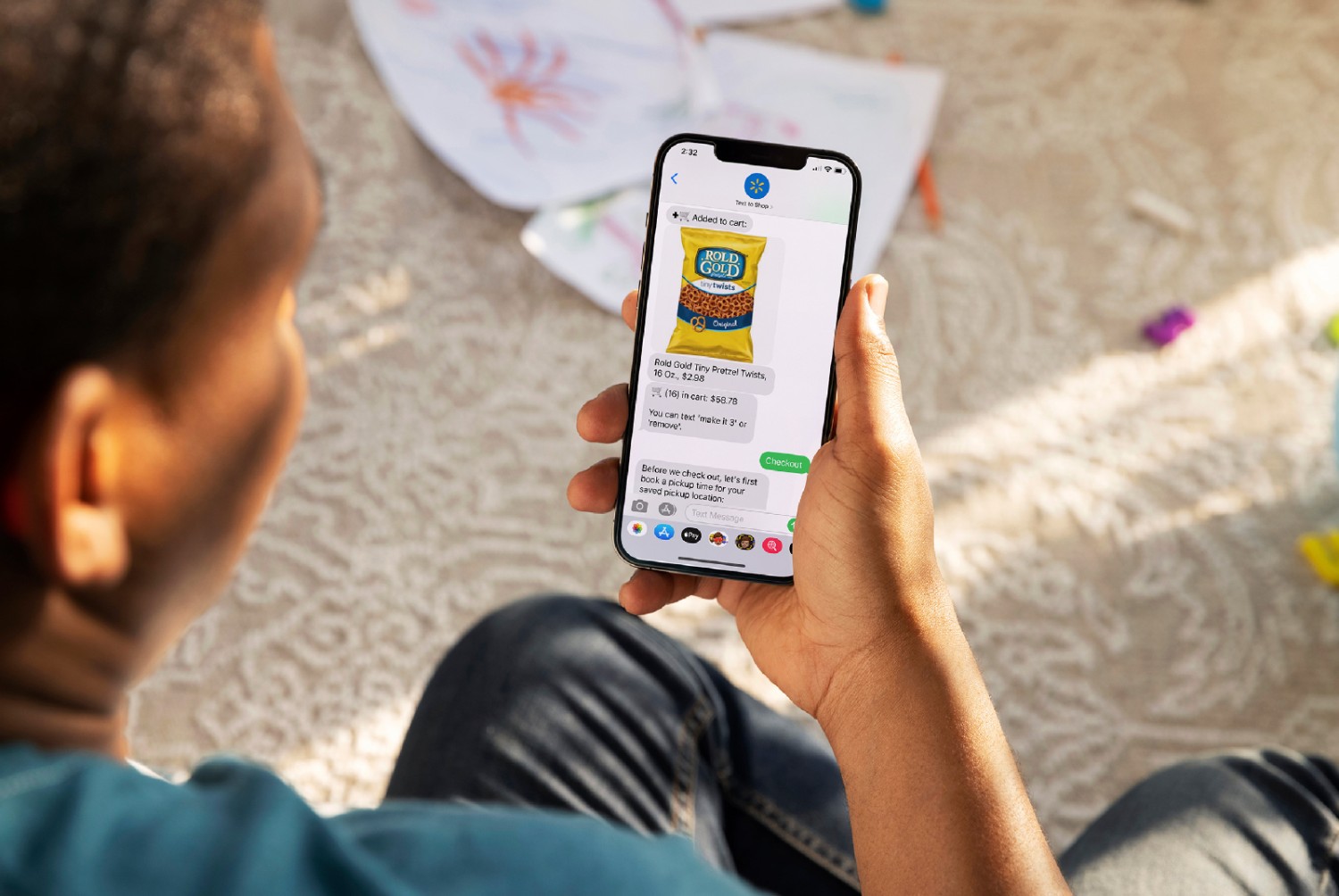  The image​￼​​￼​ shows a man ordering a product using the text-to-shop feature on the Walmart app.